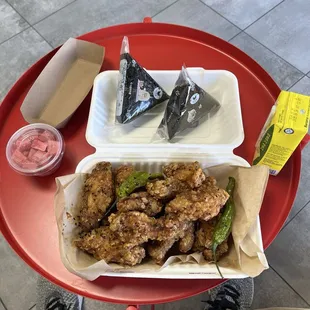 Korean fried chicken, complimentary pickled radish, rice balls, and banana milk