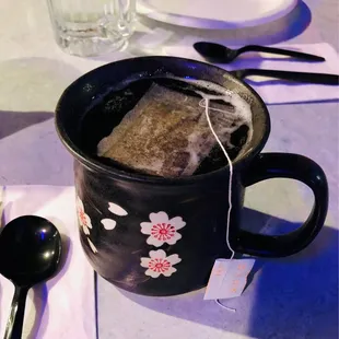 a cup of tea with a tea bag in it