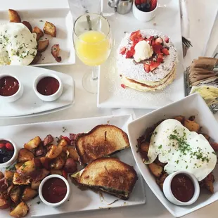Eggs and potatoes, pancakes, corned beef hash, and truffle cheese and egg panini