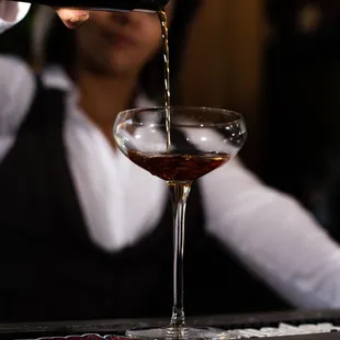 a bartender pouring a drink