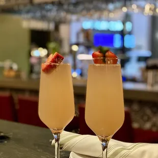 two glasses of champagne with strawberries