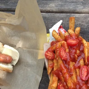a hot dog with ketchup and french fries