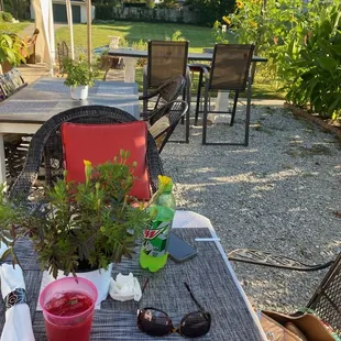 a table and chairs outside with a table cloth on it