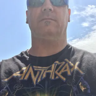 a man wearing sunglasses and a t - shirt