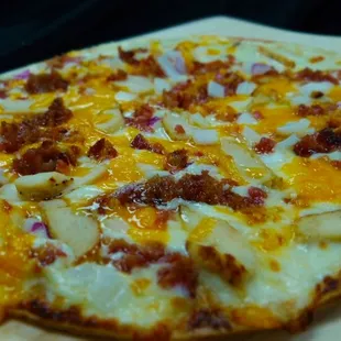 a pizza on a wooden board