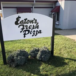 a sign for eaton fresh pizza