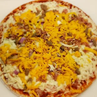 The raw bacon cheeseburger pizza.