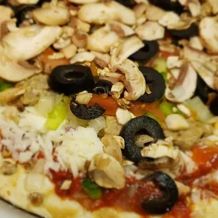 a pizza with mushrooms, peppers, and cheese