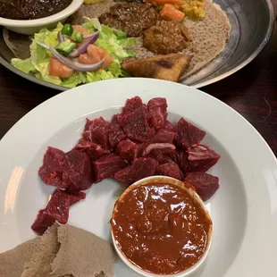 Kurt -- my husband's favorite (raw steak); and a veggie platter, doro wot, and a lentil sambusa peeking out of the background.