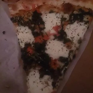 1 slice of mozzarella, spinach and tomato pizza. Yum