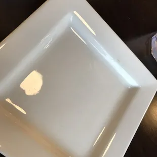 a white square plate on a table