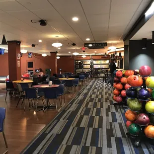 a bowling alley with tables and chairs