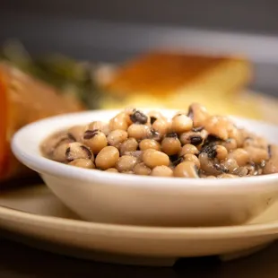 a bowl of black eyed peas and carrots