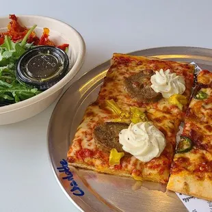 Pizza and salad on a table!