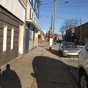 the shadow of a person on the sidewalk