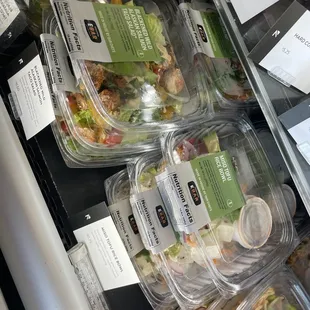 a variety of salads in plastic containers