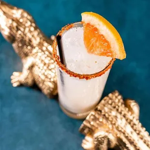 a cocktail garnished with a slice of orange