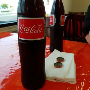 a bottle of coke and a napkin on a table