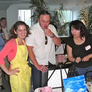  a group of people standing around a table
