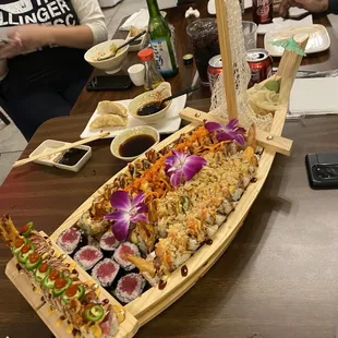 a long wooden boat filled with sushi