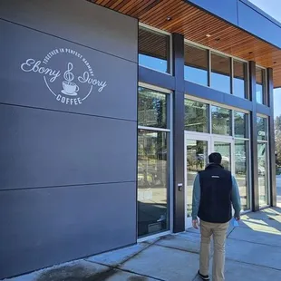 a man walking in front of a building