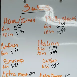 a white board with orange writing