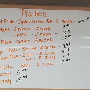 a whiteboard with a price list on it