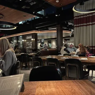 people sitting at tables in a restaurant