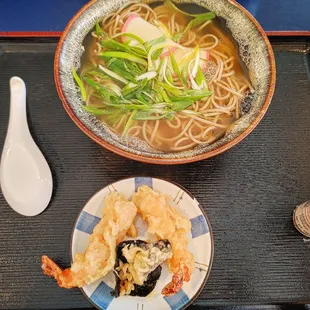 a bowl of ramen and a plate of shrimp