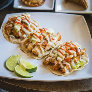 Korean Tacos. Flour tortilla, house made taco sauce, lettuce, Pico de Gallo, pickles, topped with sriracha and mayo.