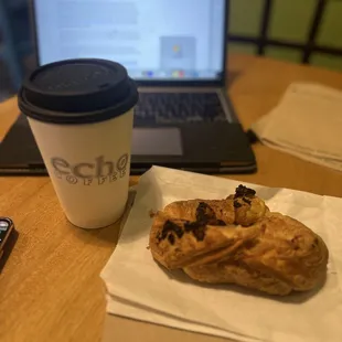 a doughnut and a laptop on a table