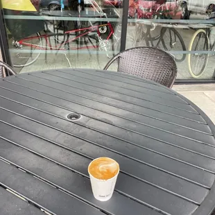 Cappuccino outside in front of the bike store next door.