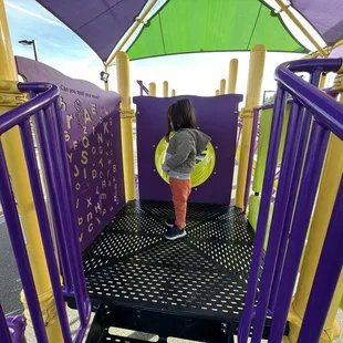 Reading the letters on the smaller play structure