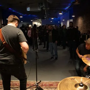 a man playing the drums in front of a crowd