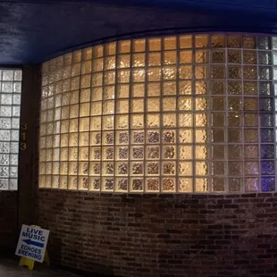 a brick building with a glass block wall