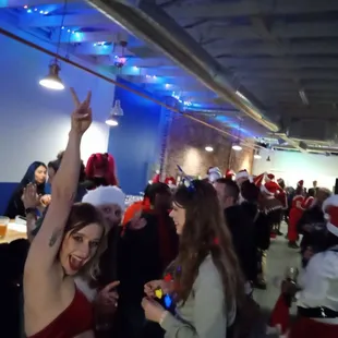 a group of people dressed in santa hats
