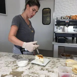 Creme brulee crepe cake being blow torched