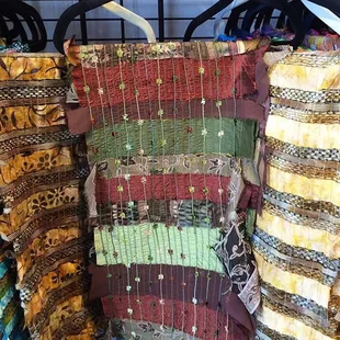 Scarves that are meticulously crafted with up-cycled fabrics. Lightweight silks, cotton, wool, or fabulous bead work!