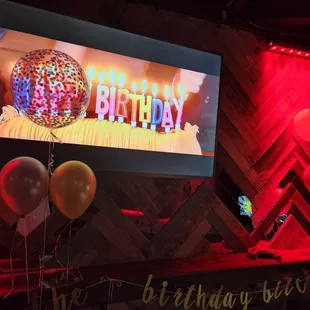 a birthday party with balloons and a disco ball