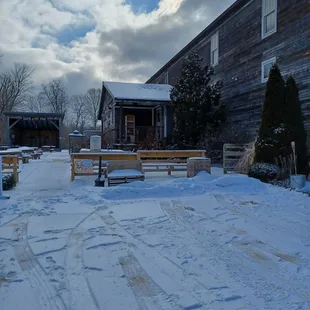 a snow covered driveway with benches