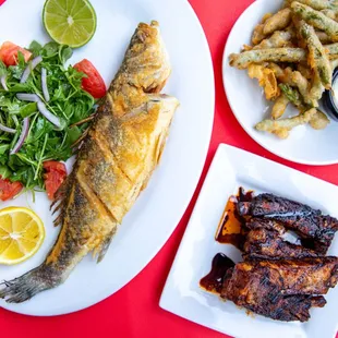 a plate of fish, salad, and fries