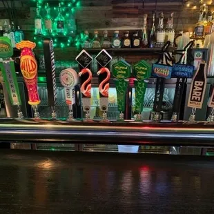 a row of beer taps on a bar