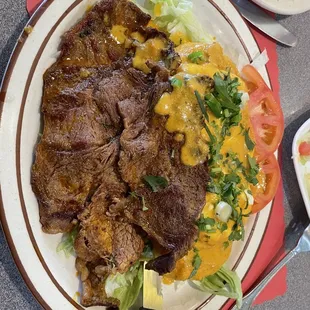 a plate of steak and rice