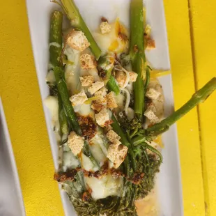 Roasted broccolini with raclette cheese, croutons, and candied lemon zest.