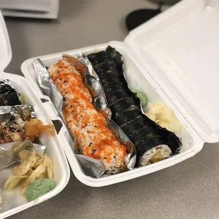 two take out containers of sushi