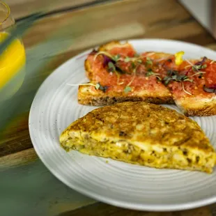 a plate of food and a glass of orange juice
