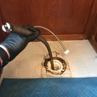 Drain cleaning toilet line