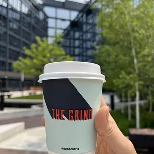 a hand holding a cup of coffee