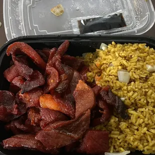 a plastic container filled with rice and meat