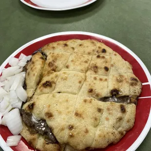 Pljeskavica Sa Kajmakom (Pita bread with meat and a type of cream cheese)